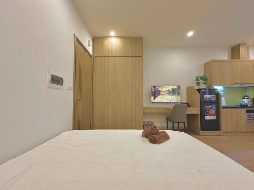 a bedroom with a bed with a teddy bear on it at Happy Home - Big Balcony - Best Location in Hanoi