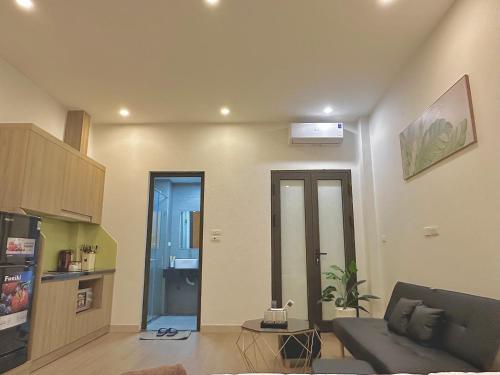 a living room with a couch and a table at Happy Home - Big Balcony - Best Location in Hanoi