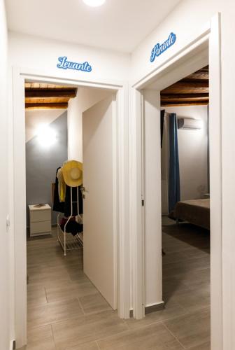 a room with white walls and doors with a bed at La Praiola in Trappeto