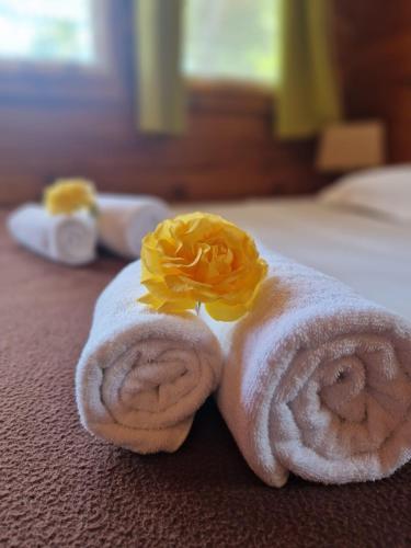 - une serviette avec une fleur au-dessus du lit dans l'établissement Mare E Monti, à Porto Pollo