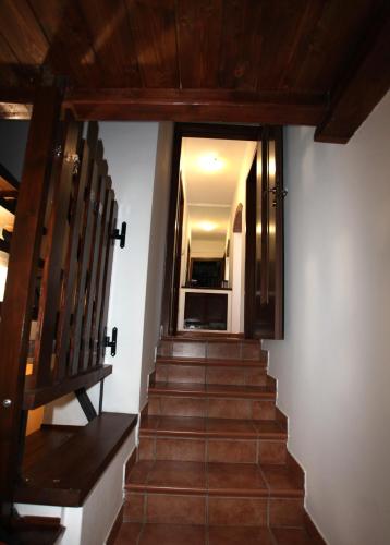 a staircase with wooden floors and a glass door at Dimora La Favorita in San Miniato