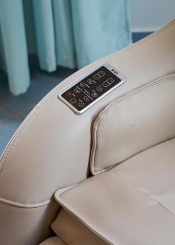 a remote control sitting on the back of a couch at Porfyra Suite 1 in Skala