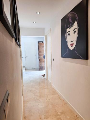 a hallway with a painting of a woman on the wall at Villa Serenità by Prolocal in Cunit