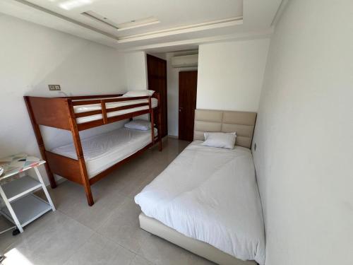 a small room with two bunk beds in it at PUERTO MARINA ASILAH in Asilah