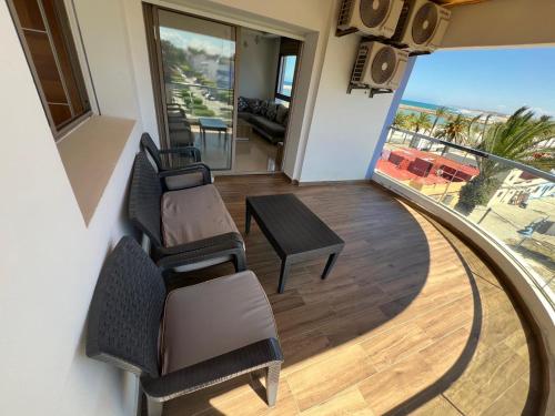 a room with two chairs and a table and a balcony at PUERTO MARINA ASILAH in Asilah