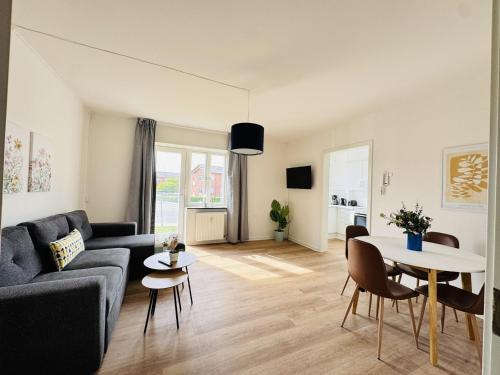 a living room with a couch and a table at aday - Lodsejervej Suite 4 in Randers