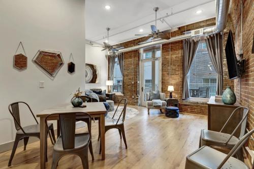 a dining room and living room with a table and chairs at The Majestic Lofts in Nashville