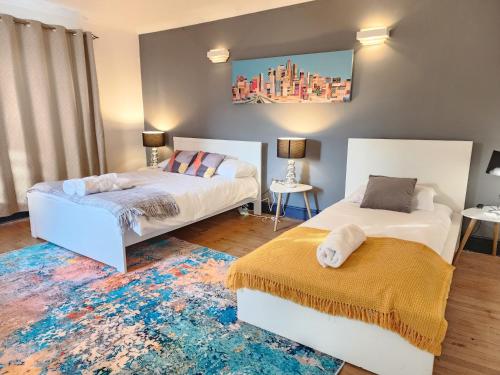 a bedroom with two beds and a rug at Paradigm Villa, Oxford,5 Bedroom, 5 Free Parking Spaces in Oxford