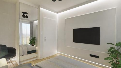a living room with a tv on a white wall at Black Velvet & Dark Elegance in Opole