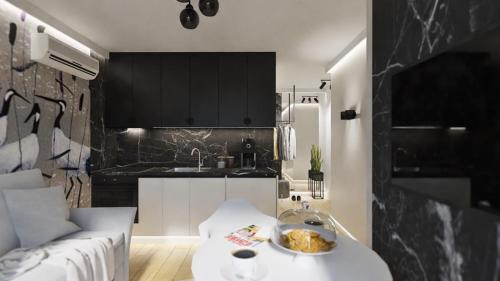 a kitchen with a couch and a table in a room at Black Velvet & Dark Elegance in Opole