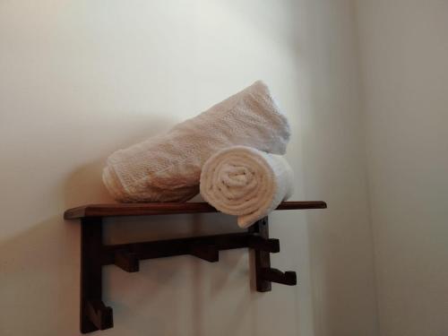 a towel sitting on a wooden shelf on a wall at Diora Hotel in Ratnapura