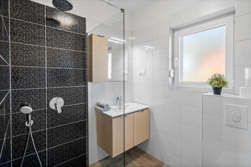a bathroom with a shower and a sink at Seaview Villa Stanka with Pool and attached Jacuzzi in Kaštela