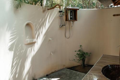 a bathroom with a urinal on a white wall at Kitesurfing Lanka in Kalpitiya