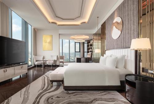 a bedroom with a large bed and a television at Radisson Blu Ha Long Bay in Ha Long