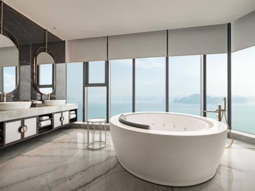 a bathroom with two sinks and a large tub at Radisson Blu Ha Long Bay in Ha Long