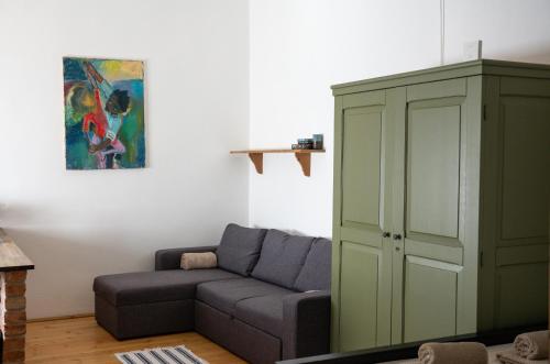 a living room with a couch and a cabinet at Mokka Vendégház in Verőce