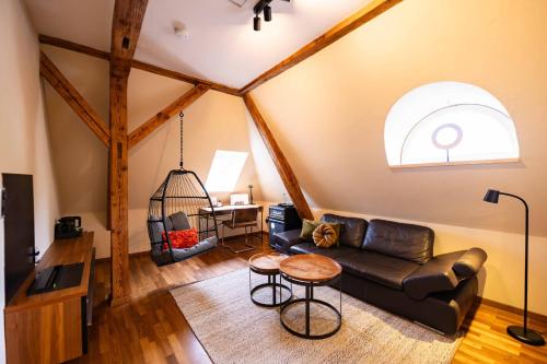 a living room with a couch and a table at Boutique-Hotel Bayerischer Hof in Kempten