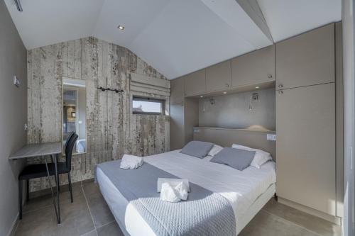 a bedroom with a bed and a desk in it at Le Pigeonnier - Vue sur le château de Menthon in Menthon-Saint-Bernard