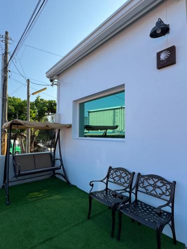 two benches on a patio with a window at Sea Travel in Xiaoliuqiu