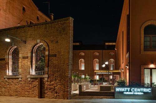 a brick building with a sign that reads work centre at Hyatt Centric Murano Venice in Murano