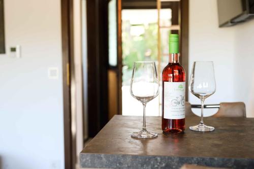 a bottle of wine and two wine glasses on a table at Ferienhaus Henneglück3 mit Sauna in Meschede