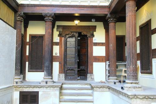 an entrance to a building with columns and a door at Deewanji Ni Haveli in Ahmedabad
