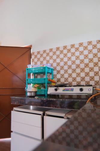 a kitchen with a stove and a counter top at Chaudhary Farm house in Daula