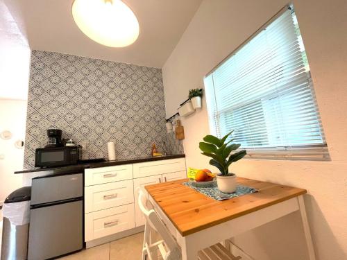 a kitchen with a table with a plant on it at Unique Studio in Little Havana Reserved Parking in Miami
