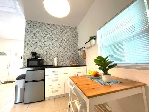 a kitchen with a table with a potted plant on it at Unique Studio in Little Havana Reserved Parking in Miami