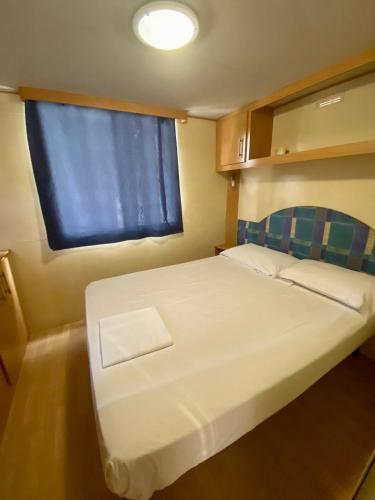 Letto o letti in una camera di Camping Internazionale Di Castelfusano
