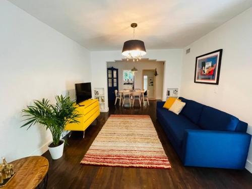 a living room with a blue couch and a table at 3 Bedroom Apartment with Backyard Oasis in Miami