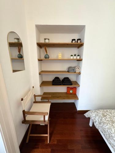 a room with a stairway with a bench and shelves at Lecco via Roma in Lecco