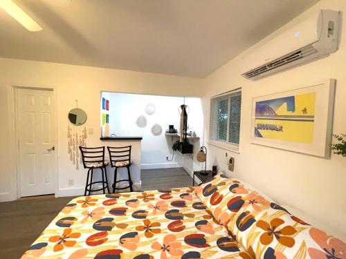 a bedroom with a bed and two chairs in it at Tropical Paradise in Miracle Mile with Parking in Miami