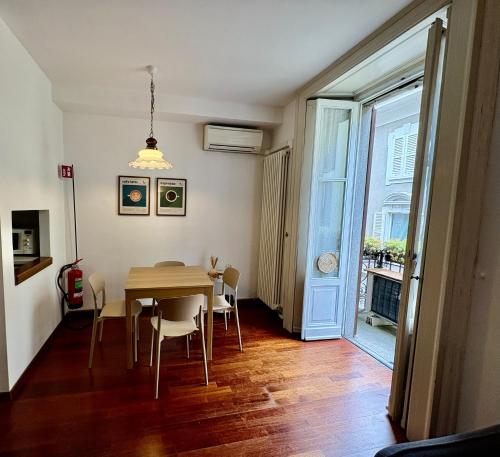 a dining room with a table and chairs and a window at Lecco via Roma in Lecco