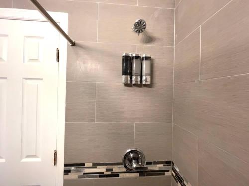 a bathroom with a shower with a sink at Tropical Paradise in Miracle Mile with Parking in Miami