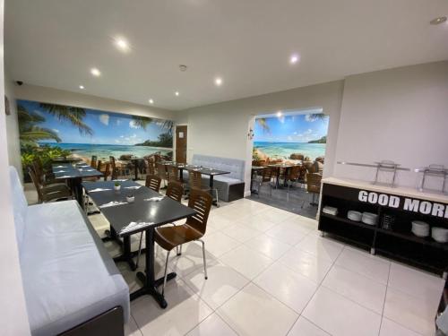 a dining room with tables and chairs in a restaurant at Trebovir Hotel in London