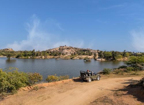 a jeep parked on a dirt road next to a river at Jawai Vilas in Mori Bera