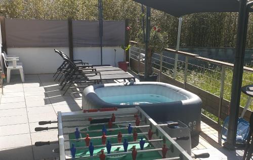 a hot tub sitting on a patio with birds on it at Etchetao in Boucau