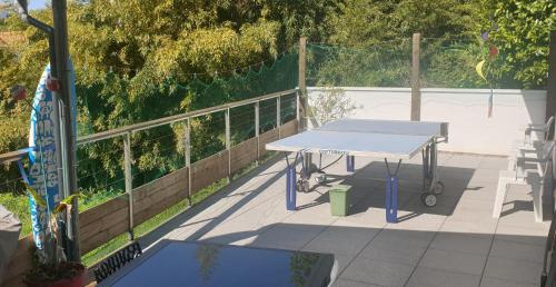 a picnic table on a patio with a fence at Etchetao in Boucau