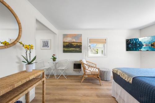 a bedroom with a bed and a desk and a table at Marina Bay Cottages in Waterford
