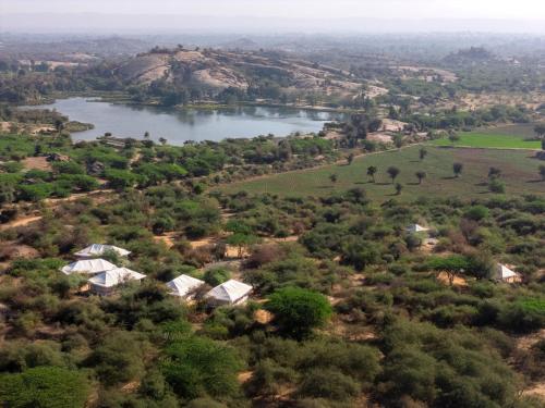 an aerial view of a river and houses at Jawai Vilas in Mori Bera