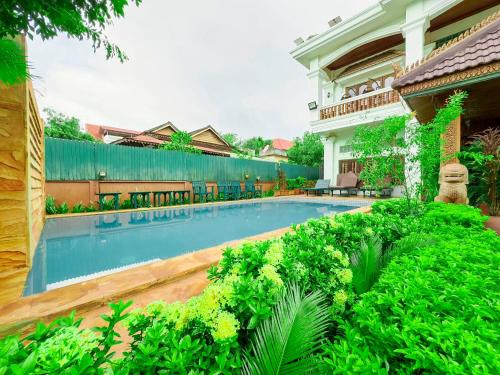 a swimming pool in the yard of a house at Shining Angkor Boutique Hotel in Siem Reap