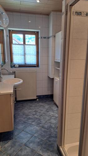 a small kitchen with a sink and a refrigerator at Dorfgasthof und Frühstückspension Tiefenbacher in Schwarzenbach an der Gölsen