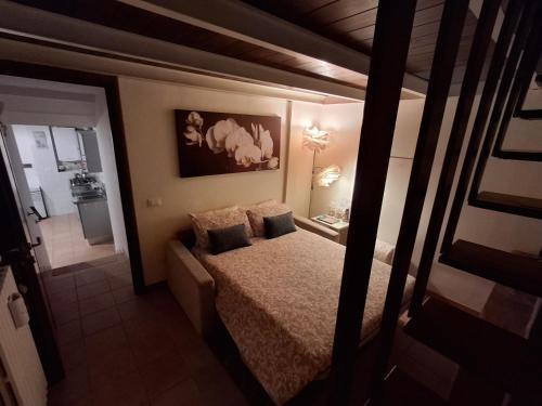 a bedroom with a bed with two pillows on it at Bilocale in strada Vestricciano Genna con giardino privato in Perugia