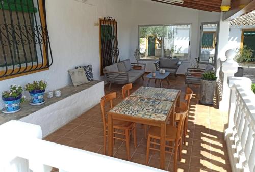 a patio with a table and chairs on a porch at CasaArabí in Arabí