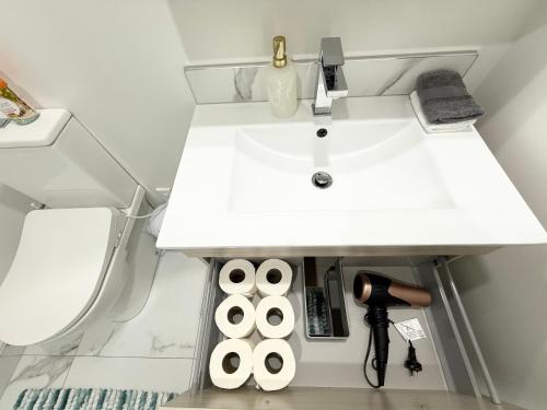 a bathroom with a sink and a white counter at CBD 2BDR 2Bath Casino TownHall TePae Convention center FREE carpark in Christchurch