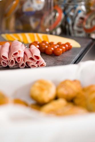 a plate of food with meat and a plate of tomatoes at Scott's Hotel in Killarney