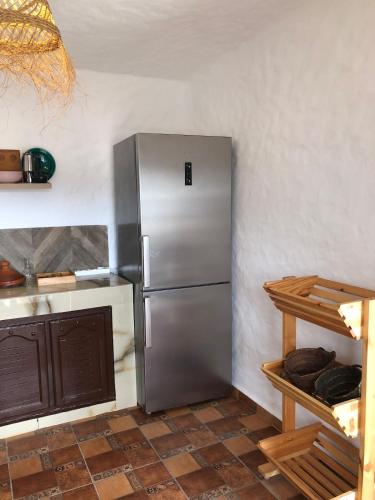 a kitchen with a stainless steel refrigerator in a room at Villa Thalassa in Oulad Akkou