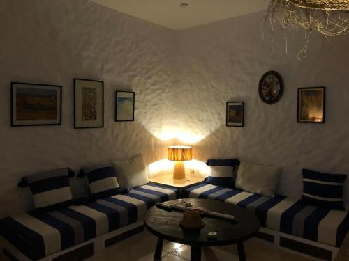 a living room with a couch and a table at Villa Thalassa in Oulad Akkou
