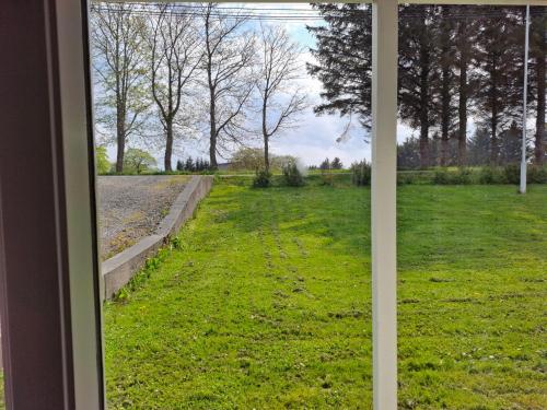 a view of a field from a window at Apartment in the heart of Sunnmore in Vigra